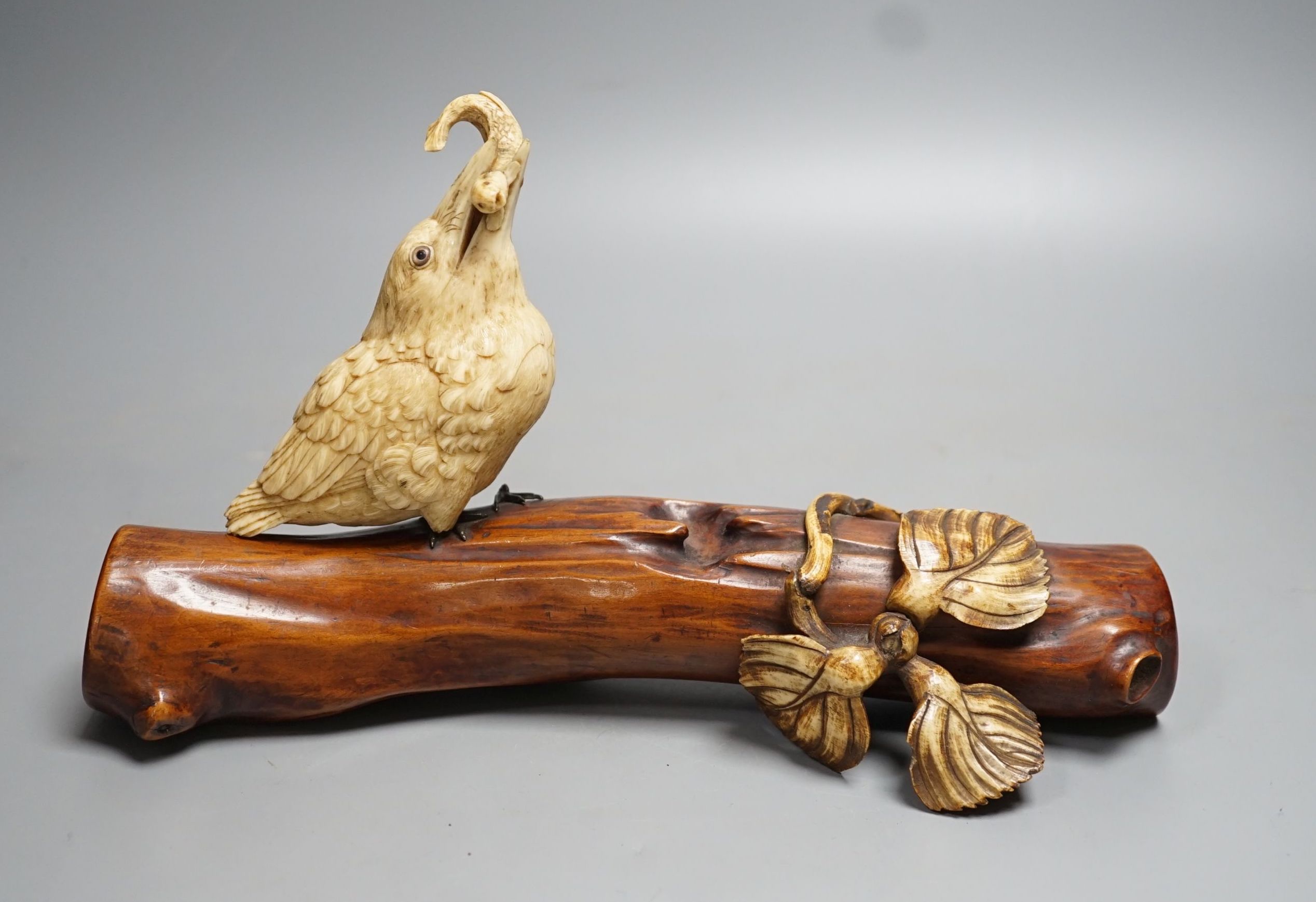 A 19th century Japanese ivory okimono of a kingfisher and log, mother of pearl inset eyes, signed to underside (a.f) 25cm long